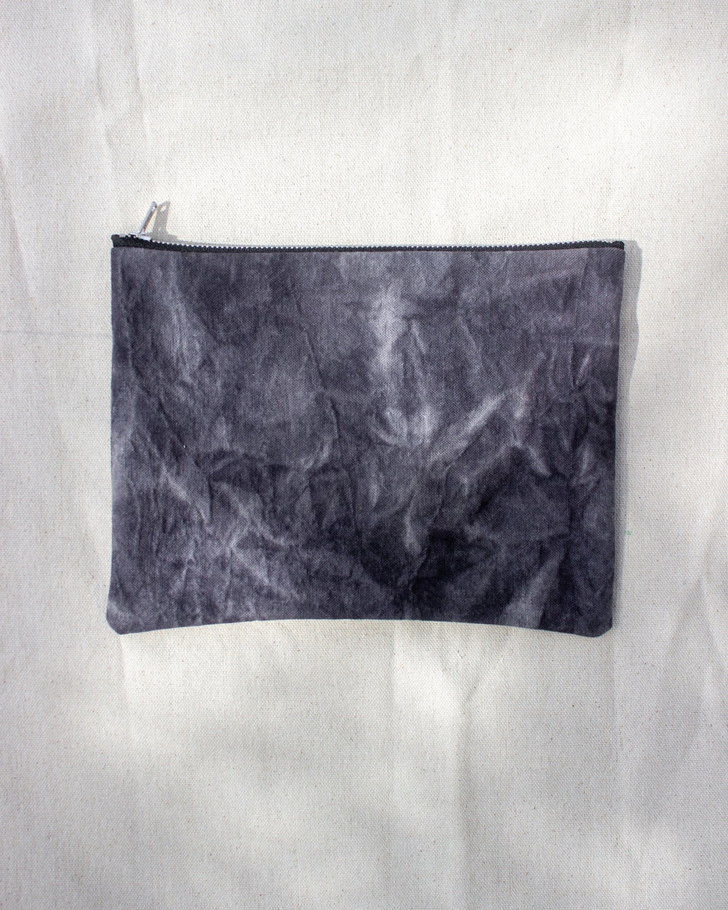 Black textured pouch on a white background