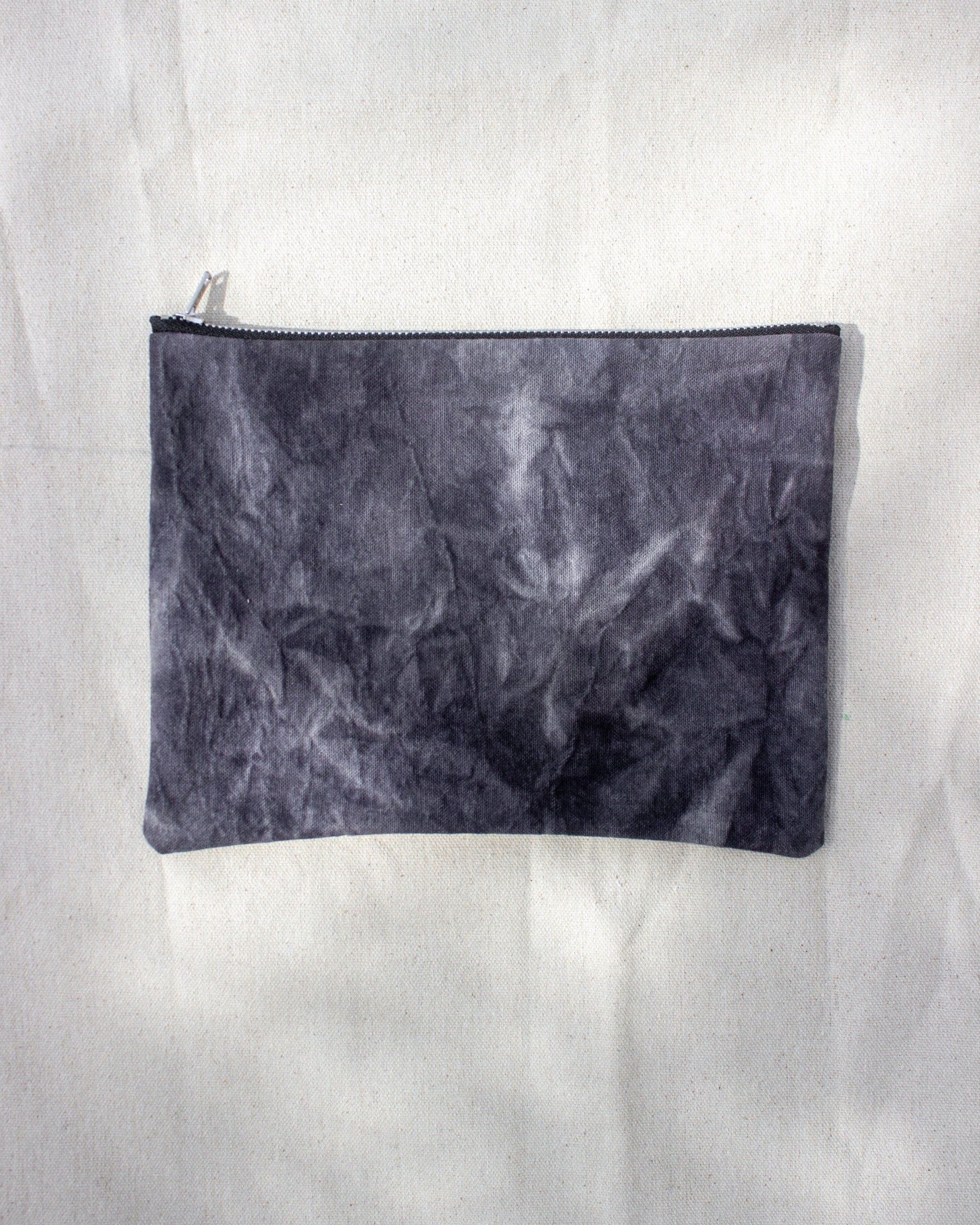 Black textured pouch on a white background